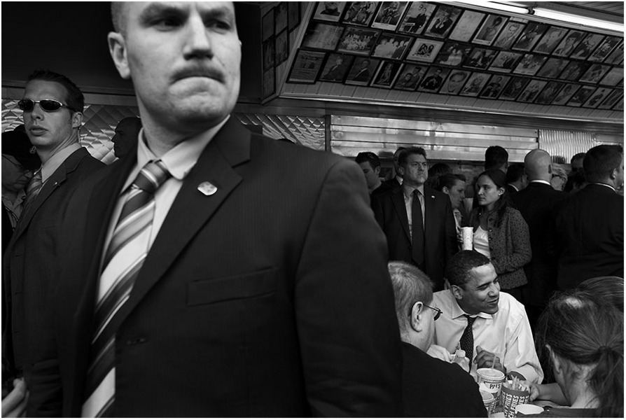 A Secret Service agent keeps watch as Obama lunches on a cheesesteak in Philly. : The Rise of Barack Obama : Pete Souza Photography